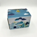 Illustrated gift box for the By The Sea Whale Cup featuring waves, clouds and sailboat artwork