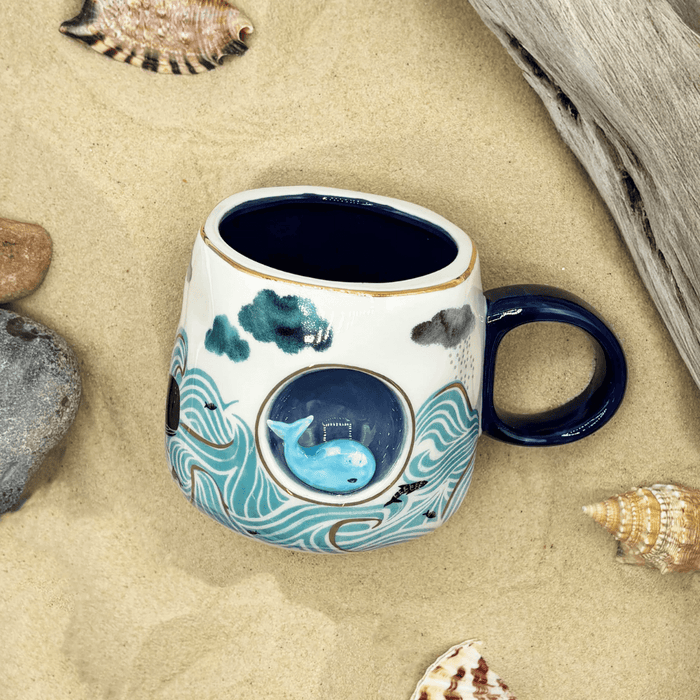 Overhead lifestyle view showing the wave artwork, gold accents and dark blue handle