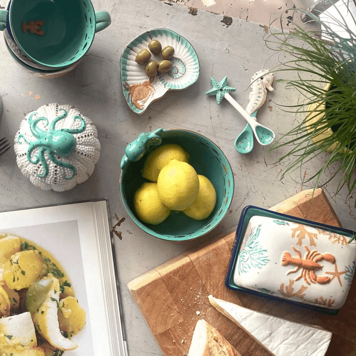 Flatlay featuring the Coral Octopus Bowl alongside coordinating sea-themed ceramics