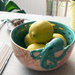Lifestyle shot of the bowl filled with lemons showing the octopus detail and gold accents