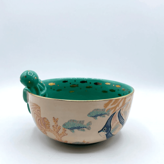 Profile view showing fish and coral artwork around the outside of the bowl
