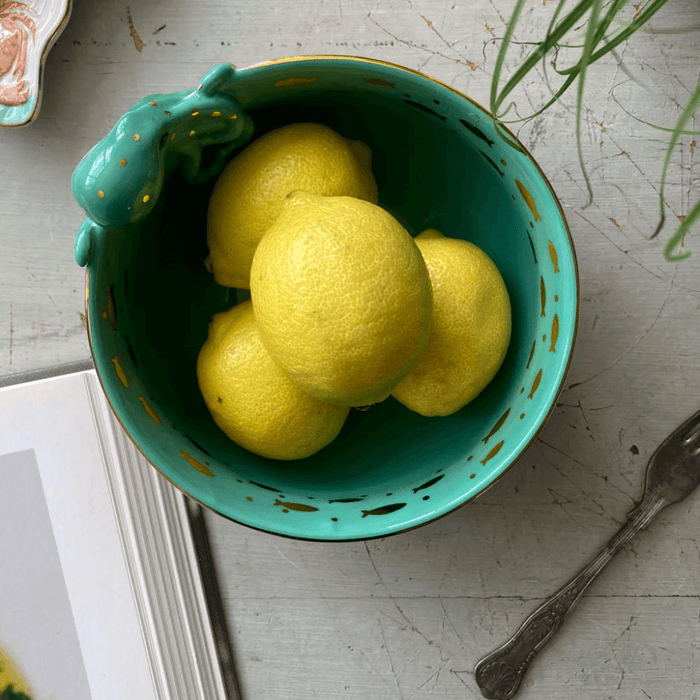 Overhead view of the teal interior with gold-foil touches and lemons inside