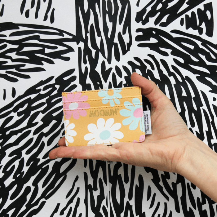 House of Disaster Moomin floral card holder held in hand showing the pastel floral back design