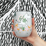 House of Disaster Moomin Floral keep cup held in hand showing Moomin character and pastel floral design