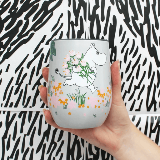 House of Disaster Moomin Floral keep cup held in hand showing Moomin character and pastel floral design