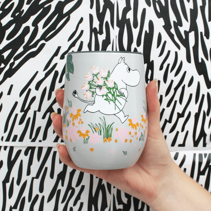 House of Disaster Moomin Floral keep cup held in hand showing Moomin character and pastel floral design