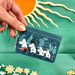 House of Disaster Moomin Forest card holder held in hand showing the front woodland character design