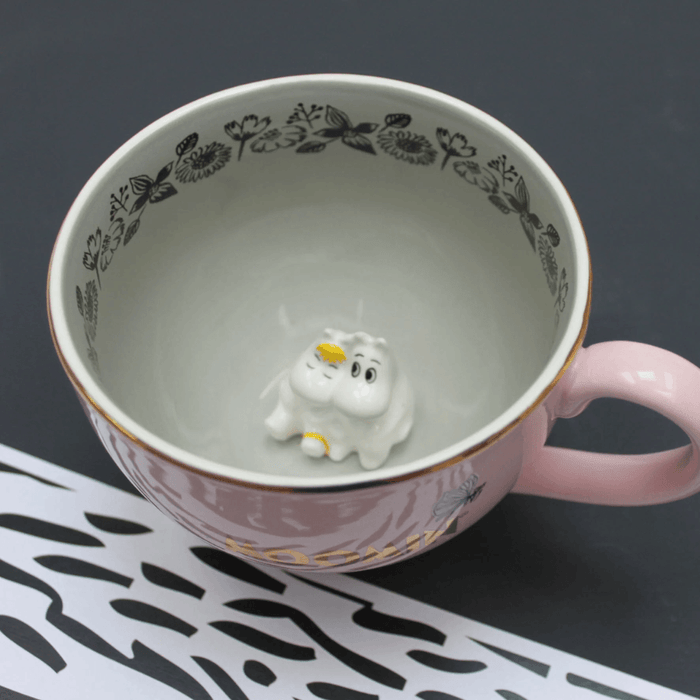 Top view inside House of Disaster Moomin Love cup showing hidden 3D Moomin and Snorkmaiden figure