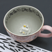 Top view inside House of Disaster Moomin Love cup showing hidden 3D Moomin and Snorkmaiden figure