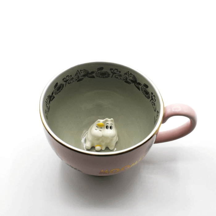 Front angled view inside House of Disaster Moomin Love cup showing the 3D Moomin and Snorkmaiden figure