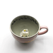Front angled view inside House of Disaster Moomin Love cup showing the 3D Moomin and Snorkmaiden figure