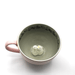 Rear angled top view of House of Disaster Moomin Love cup with hidden 3D character detail inside
