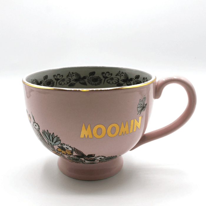 Side view of House of Disaster Moomin Love porcelain cup with gold Moomin logo and floral artwork