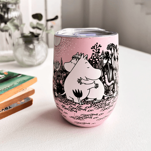 House of Disaster Moomin Love keep cup on a table with books and vase showing front hugging character design