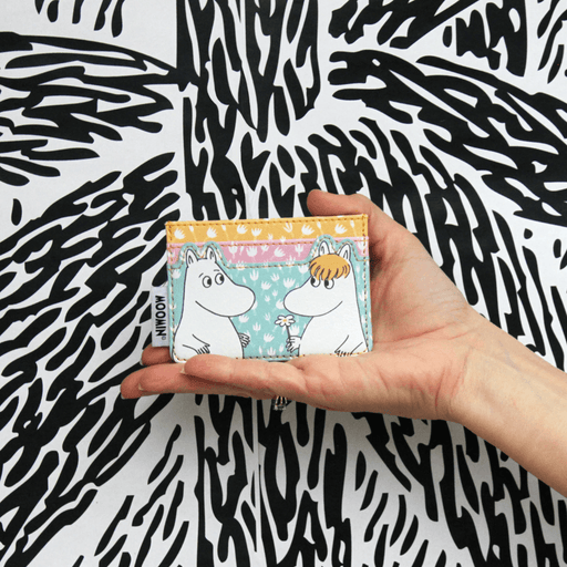 House of Disaster Moomin floral card holder held in hand showing Moomin and Snorkmaiden on the front