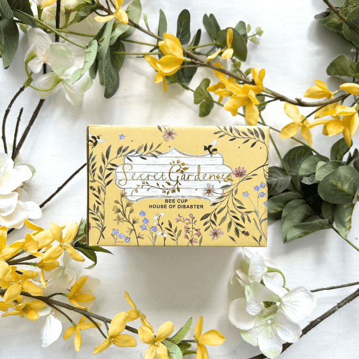 Front of the printed gift box with Secret Garden artwork and Bee Cup label