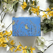 Back of the gift box featuring blue bird and wildflower illustrations