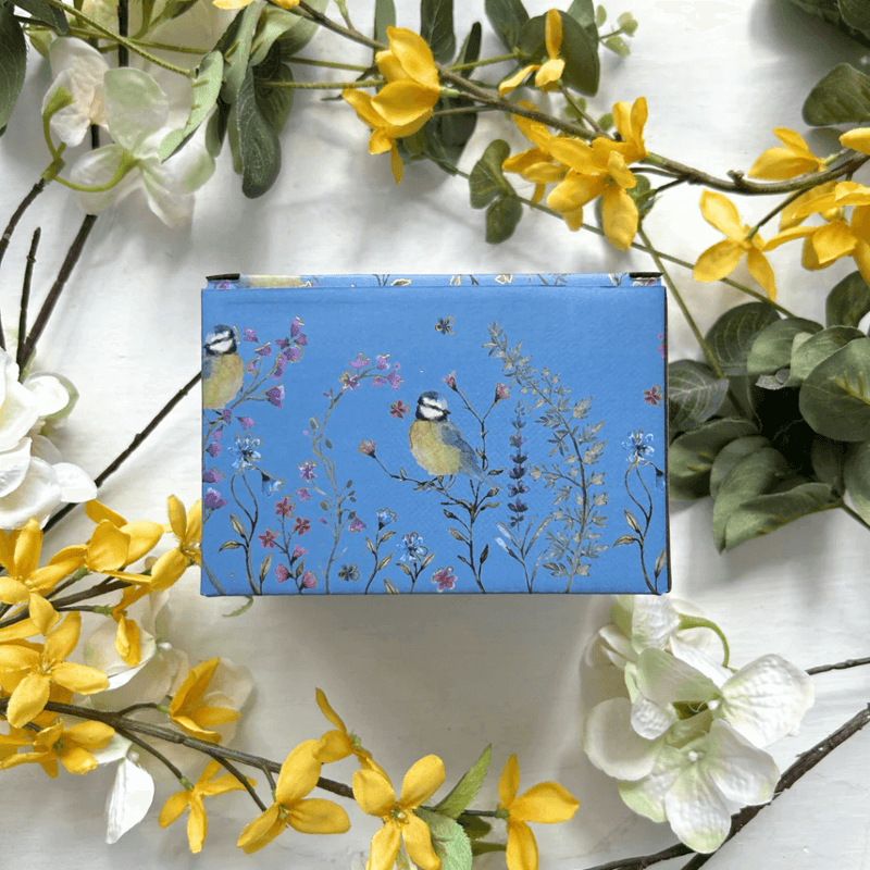 Back of the gift box featuring blue bird and wildflower illustrations