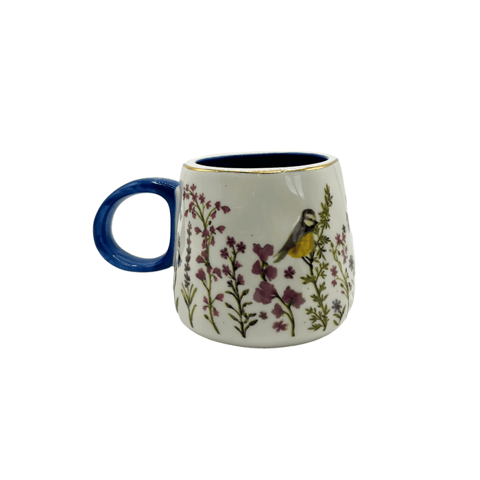 Side view of the Secret Garden 3D Bird Cup with wildflower print, blue handle and gold-foil rim