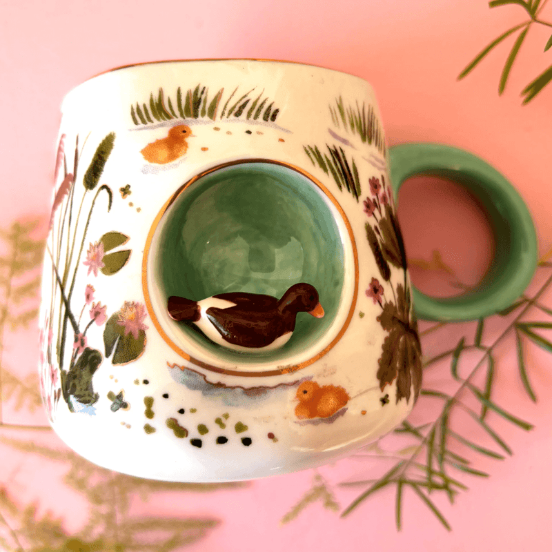 Close-up of the House of Disaster Secret Garden mug with a 3D ceramic duck
