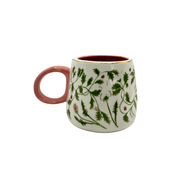 Rear view showing the pink handle and foliage pattern wrapping around the cup