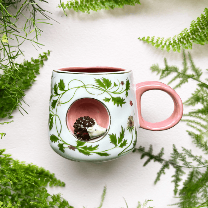Lifestyle photo of the Secret Garden 3D Hedgehog Cup styled with greenery