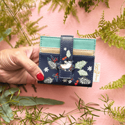 House of Disaster Secret Garden Bird Purse held in hand, showing front bird design