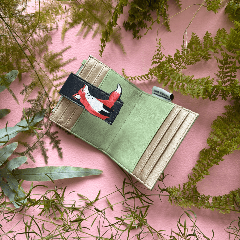 House of Disaster Secret Garden Fox Foldover Cardholder open, showing card slots and zip pocket on pink background