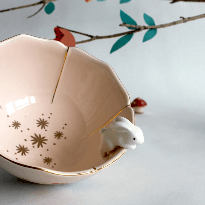 Angled view showing the blush interior, gold accents and scalloped flower rim