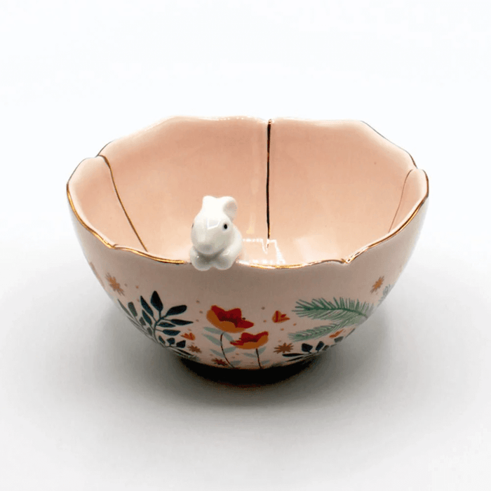 Front view of the flower-shaped bowl with gold rim detailing and rabbit figure