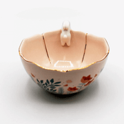 Side view showing the colourful foliage print and gold detailing on the outside