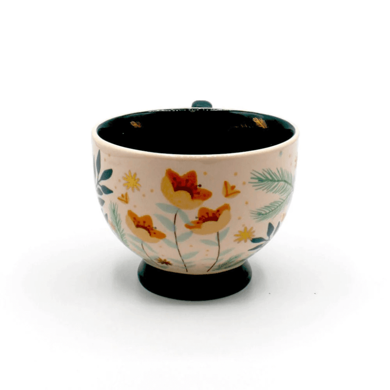 Front view of the cup showing floral illustrations, gold details and teal interior