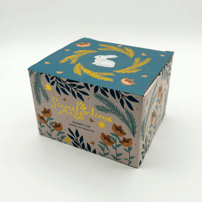 Printed gift box for the Secret Garden Rabbit Cup with gold details on the packaging