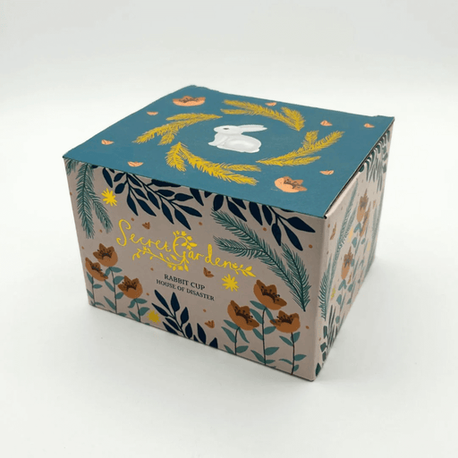Printed gift box for the Secret Garden Rabbit Cup with gold details on the packaging