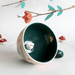 Lifestyle shot of the Secret Garden Rabbit Cup showing the teal interior and hidden rabbit inside