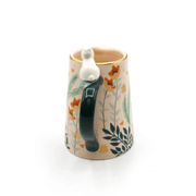 Rear view of the jug focusing on the handle and the rabbit perched at the top