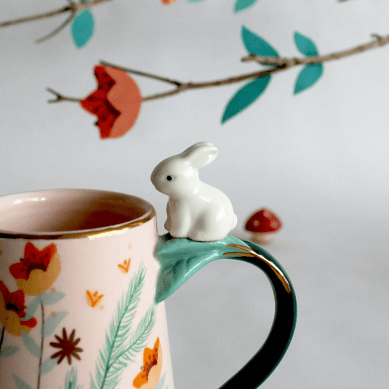 Close-up of the ceramic rabbit perched on the handle with gold detailing