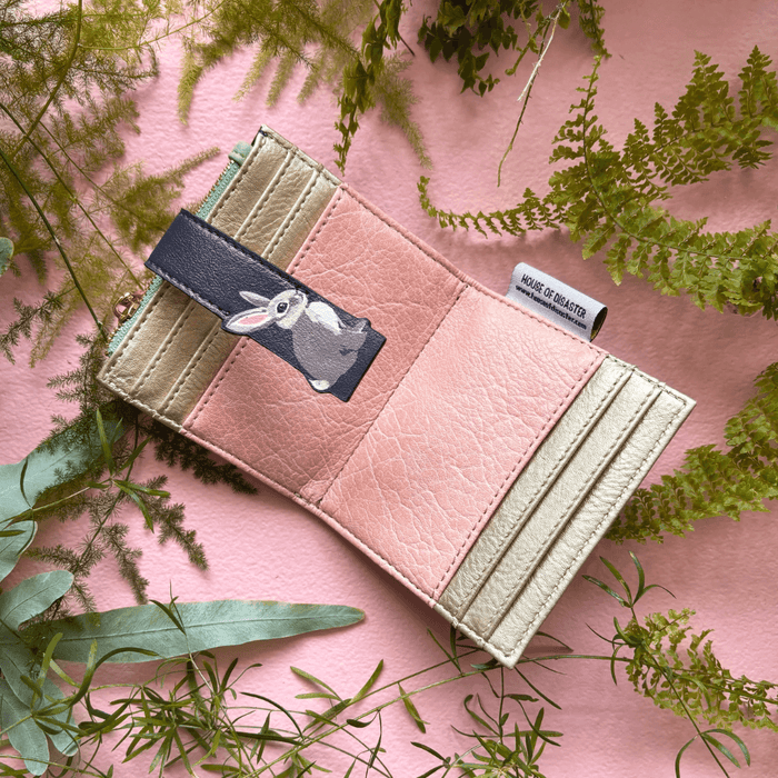 House of Disaster Secret Garden Rabbit Purse open, showing pink interior and card slots on pink background