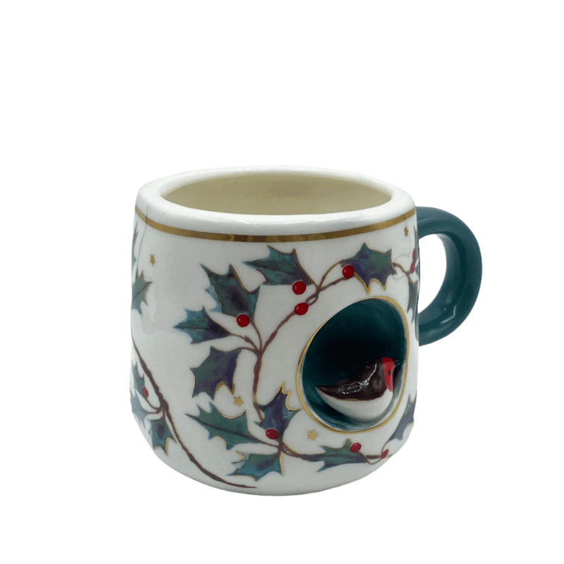 Angled view showing the holly pattern, gold-foil rim and 3D robin nook detail