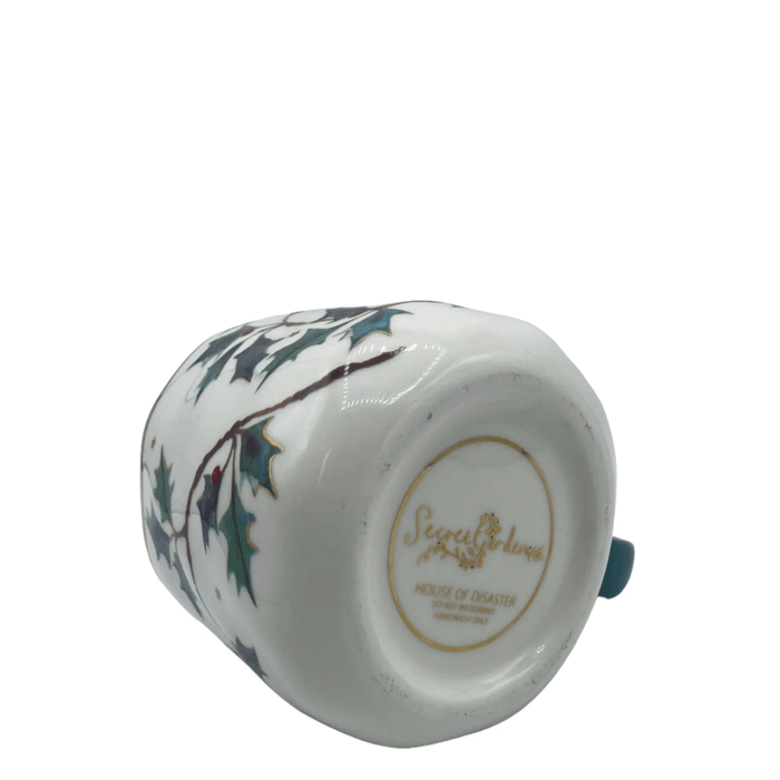 Base of the cup showing Secret Garden branding and care instructions