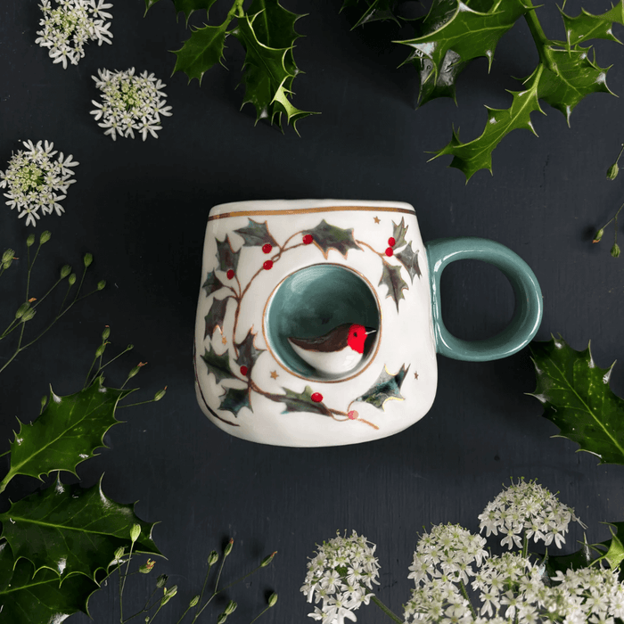 Overhead flatlay of the Robin Cup on a dark festive background with greenery
