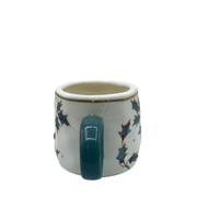 Rear view focusing on the green handle and holly print on the side