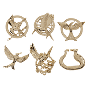Six Hunger Games gold-tone mystery enamel pins featuring different Mockingjay and prequel symbols