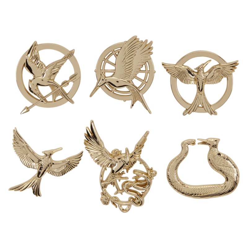 Six Hunger Games gold-tone mystery enamel pins featuring different Mockingjay and prequel symbols