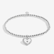 Full view of Joma Jewellery A Little Like A Mum To Me Bracelet, silver-plated beaded stretch Bracelet with sparkly heart charm.