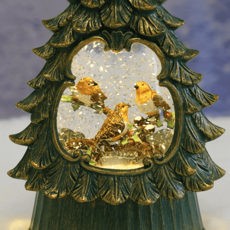 Close-up of illuminated robin Christmas tree water spinner with swirling glitter