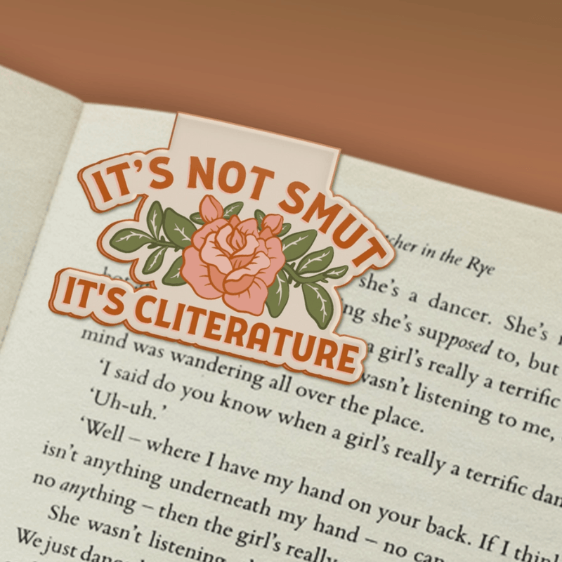 It's Not Smut It's Cliterature magnetic bookmark marking a page in a book