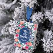 Jane Austen Pride and Prejudice book shaped tree decoration on a snowy Christmas tree