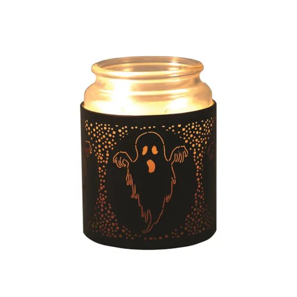 Jar candle glowing inside ghost-themed wax melt burner

