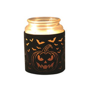 Jar candle inside Halloween wax burner with pumpkin and bats cut-out design

